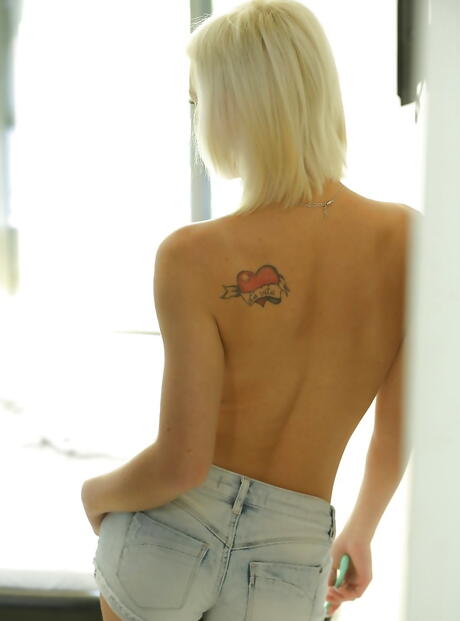 Sylphlike hungarian blond porn star Zazie Skymm in fancy shorts uncovers small tits and butt in bathroom